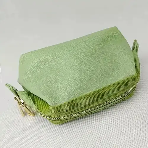 Custom branded green PU leather pouch with debossed logo options for premium gift with purchase (GWP)